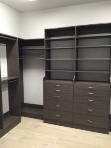 Black Wardrobe having multiple shelves in a room