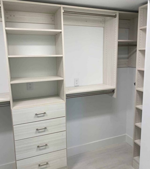 White Wardrobe having multiple shelves in a room